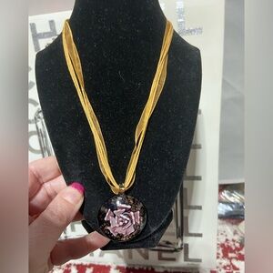 Ribbon and String Necklace With a Glass Pendant, Containing a Center Flower